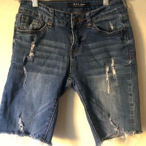 Jean shorts with slight rips on thighs and back pocket.